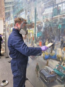 David Everingham re-varnishing the painting