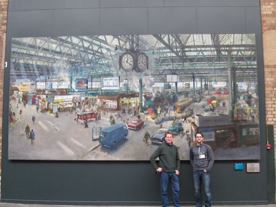 David and Mike stand proudly in front of the repaired - and revitalised - painting